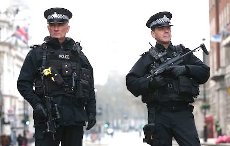 Armed police officers secure the area